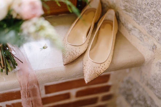 istock Bride's ballet flats with shiny stones on the windowsill by the stone wall. 1278388212