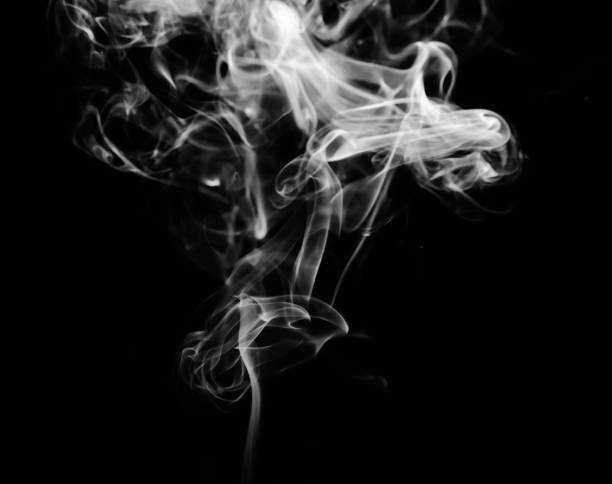 istock abstract fragment movement of white smoke on black background. 1278388412