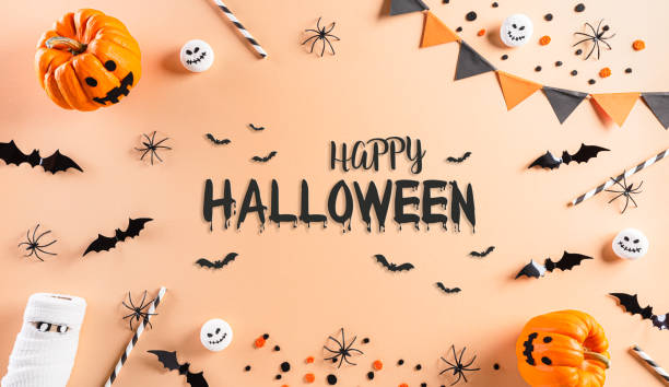 istock Halloween decorations made from pumpkin, paper bats and black spider on pastel orange background. Flat lay, top view with Happy Halloween text. 1278389645