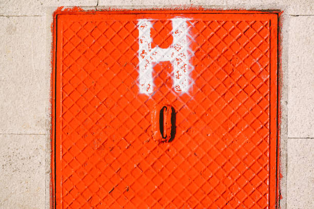 Bright red square floor hatch with a large white H.