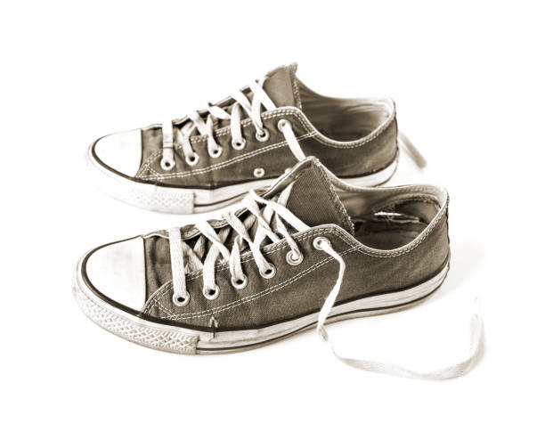 istock Old black sneakers isolated on white background 1278391787