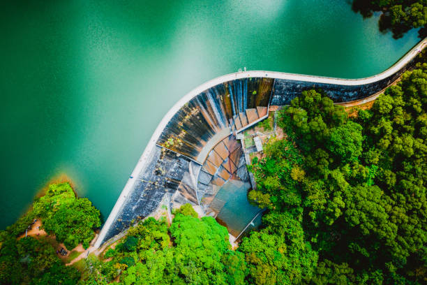 View of Ho Pui Reservoir Ho Pui Reservoir is located in Yuen Long, near to Pat Heung. It is an irrigation reservoir which belongs to a part of Tai Lam Country Park. The capacity of the reservoir is 500000 cubie metres, there is a dam in S-shaped, which is popular to the hikers. The reservoir has also been ranked one of the most popular scenic countrysides. hydroelectric power stock pictures, royalty-free photos & images