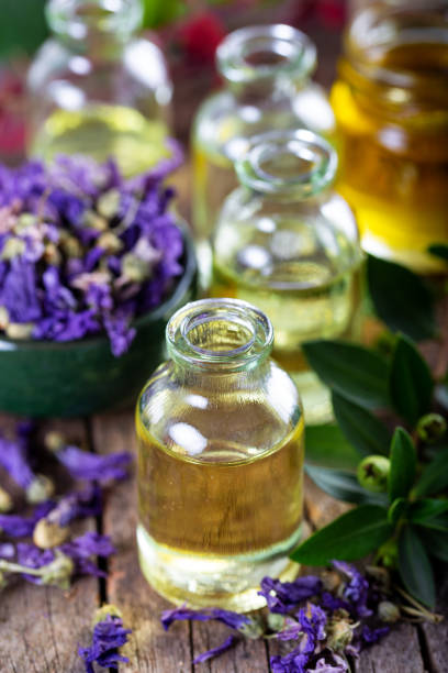 istock Essential oil bottles on medicinal cornflowers (Centaurea cyanus/bachelor's button). Selective focus. 1278395693