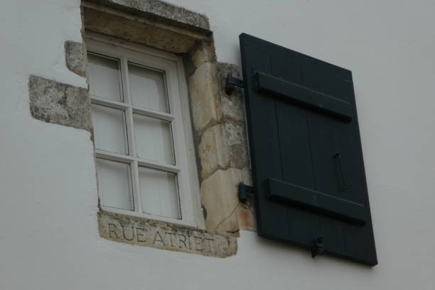 istock street name engraved in stone under the window 1278396622