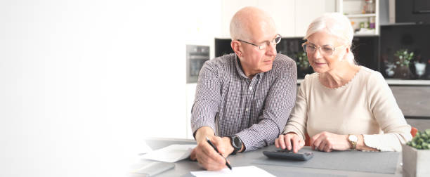 istock Senior couple calculating budget, pay the bills 1278398412