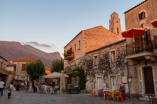 Areopoli, Greece - August 7 2020: Square full of people with traditional architecture at summer