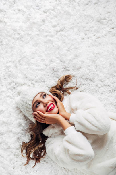 Girl lying down on the snow