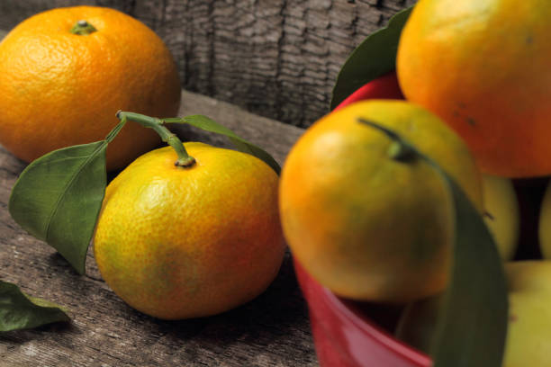 istock Tangerines, composition of citrus fruits on a rustic background. 1278404109
