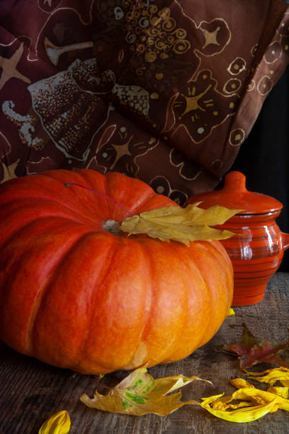 istock Orange pumpkin and brown batik cloth 1278406500