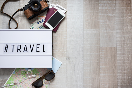 travel concept - close up of travel objects and copy space over wooden table background