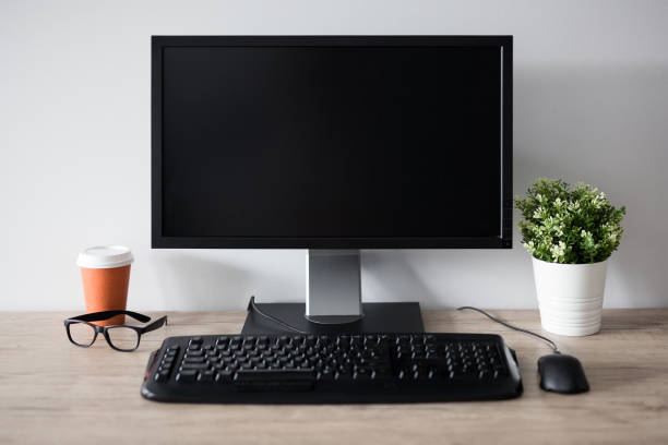 istock workplace with blank screen pc, flower pot, glasses and cup of coffee 1278406788