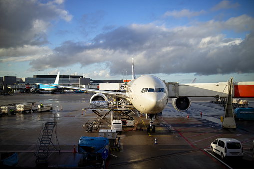 Plane and the airport in the setting sun, Airplane at the terminal gate ready for takeoff.