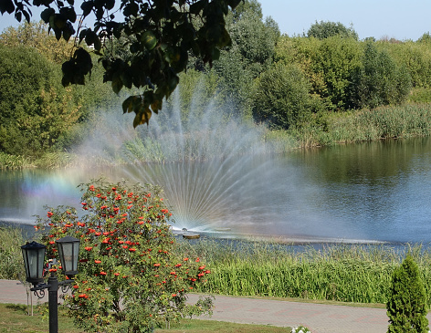 Fan fountain on the embankment of the Tsna river, on a summer day