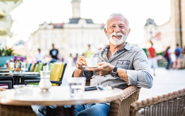 istock Happy senior man drinking coffee at cafe. 1278412764