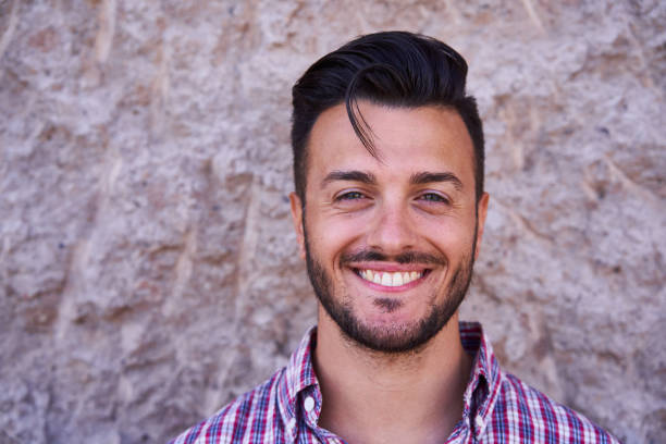 istock Handsome male standing against stone wall 1278413942