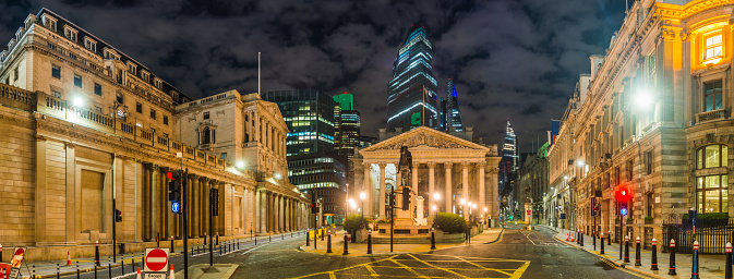 The Bank of England and institutions of the City of London Square Mile financial district illuminated at night in the heart of London, the UK’s vibrant capital city.