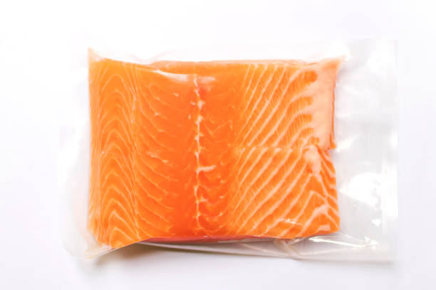 Fresh salmon fillet in vacuum package isolated on white background for delicious salmon steak. stock photo