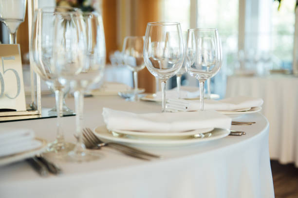 istock Luxurious restaurant. Luxurious interior, white tables, serving dishes and glasses for guests 1278427392