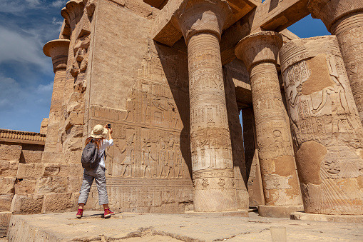 Woman take a photo in Temple of Kom ombo in Egypt