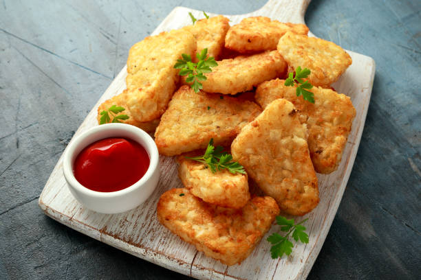 istock Hash brown potato with ketchup on white wooden board 1278429477