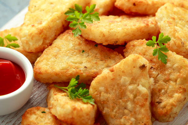 istock Hash brown potato with ketchup on white wooden board 1278430475