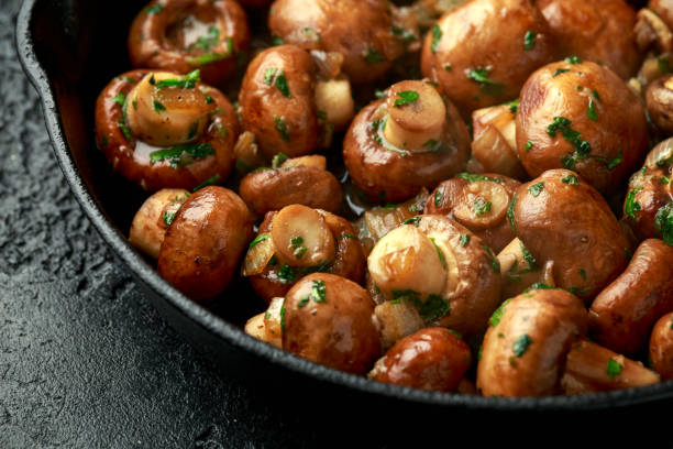 istock Fried mushrooms with onion and garlic in iron cast pan 1278430520