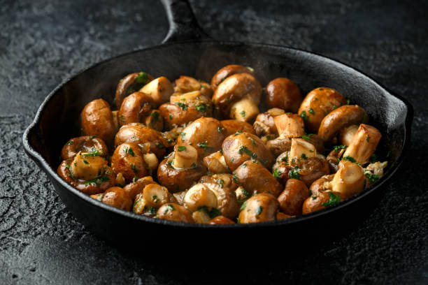 istock Fried mushrooms with onion and garlic in iron cast pan 1278430525