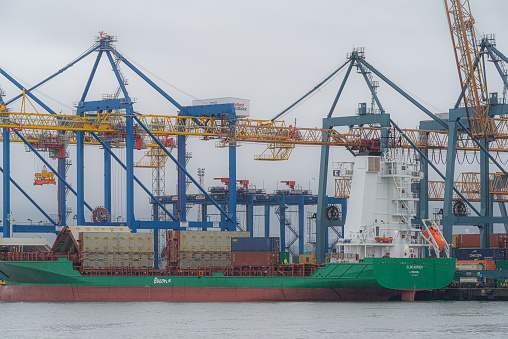 Belfast, Northern Ireland, United Kingdom - October 4, 2020:  small freighter loading its cargo at Belfast Port's container port.