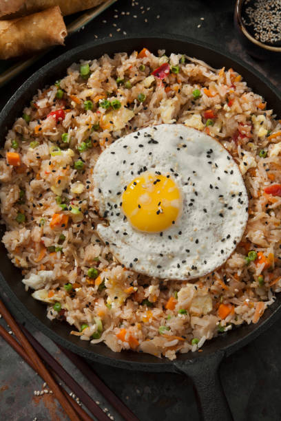 istock Spicy Korean Kimchi Fried Rice with a Fried Egg and Spring Rolls 1278432119