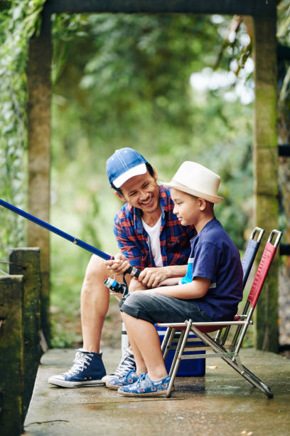 istock Man helping son with fishing 1278435001