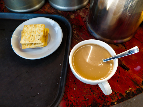 Fresh hot milk tea & biscuits with a spoon served at Tiger monastery, Bhutan.