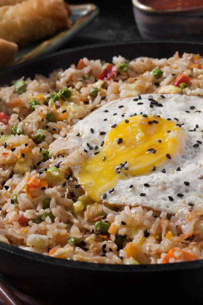 istock Spicy Korean Kimchi Fried Rice with a Fried Egg and Spring Rolls 1278436119