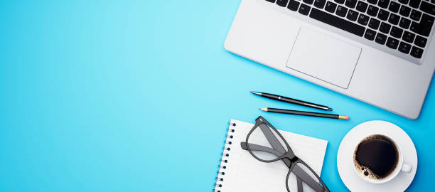 top view of a blue desktop with copy space - above laptop desk computer imagens e fotografias de stock