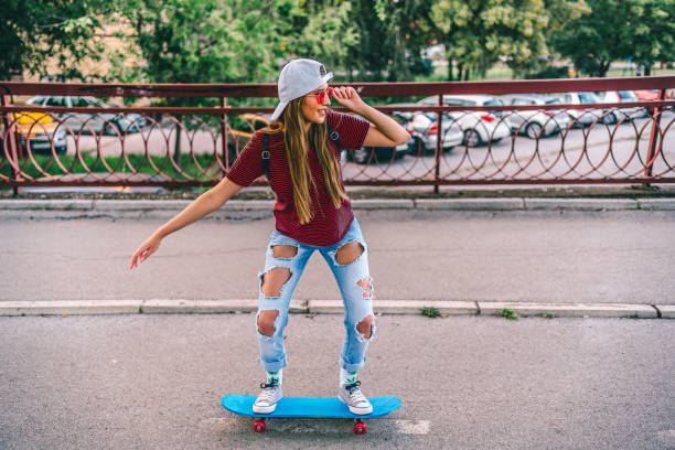 istock Young woman riding skateboard 1278436451