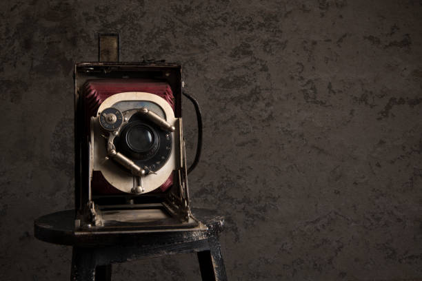 istock Antique camera on a old wall with copy space in a grunge look 1278437101