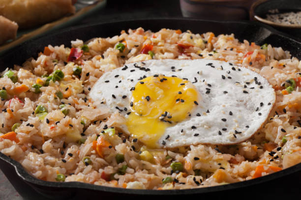 istock Spicy Korean Kimchi Fried Rice with a Fried Egg and Spring Rolls 1278439482
