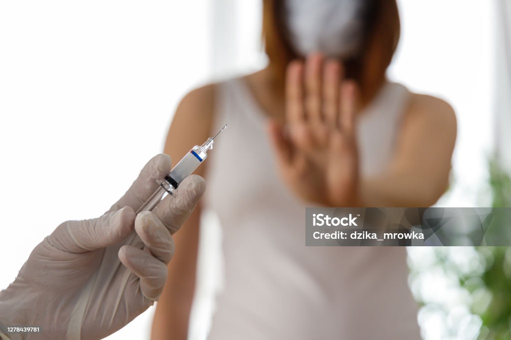 Woman wearing mask is against vaccination Vaccination Stock Photo