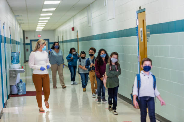 istock Students in school during covid-19, wearing masks 1278440195