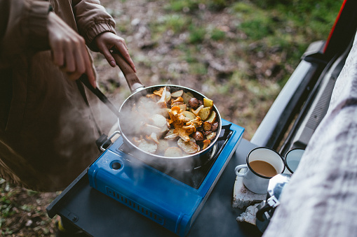Making food on camping stove in nature, from fresh ingredients.