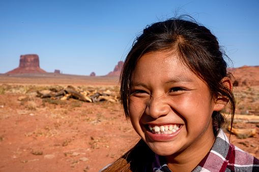 Outdoor Portrait of a beautiful Navajo Native American Indian Girl in the Northern Arizona Desert on the Monument Valley Indian Reservation