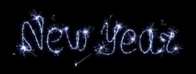 Inscription with sparklers on a black background New Year.