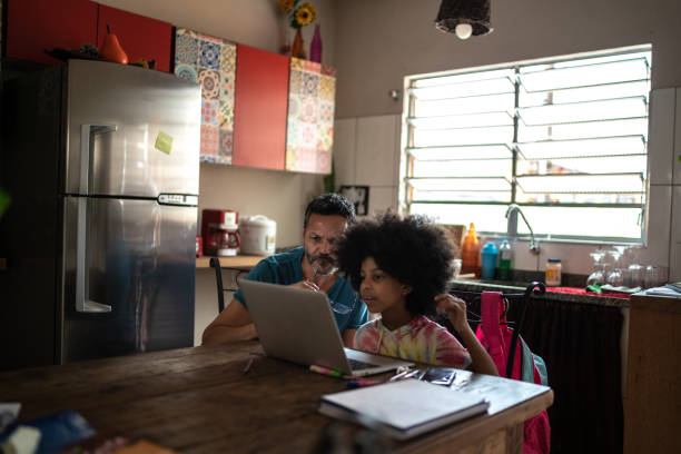 istock Father helping daughter with homework at home 1278443752