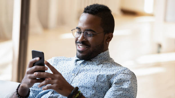 istock Relaxed 30s african american man using telephone. 1278444906