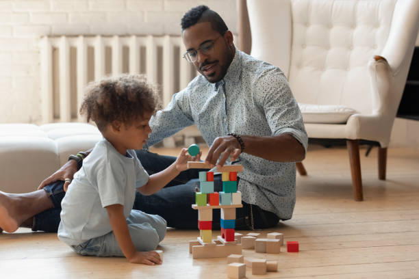 istock Caring affectionate young african american daddy playing with son. 1278444911