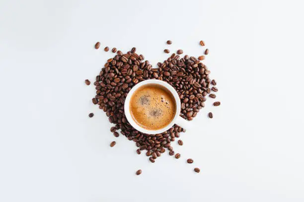 Photo of Cup of coffee Heart shape coffee beans