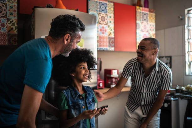 istock Family having fun using mobile phone at home 1278446746