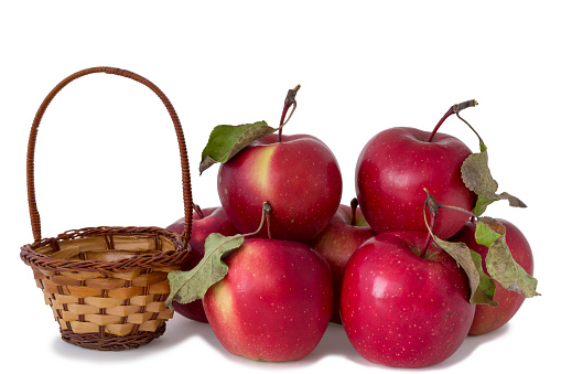 Apples and small basket on a white background.