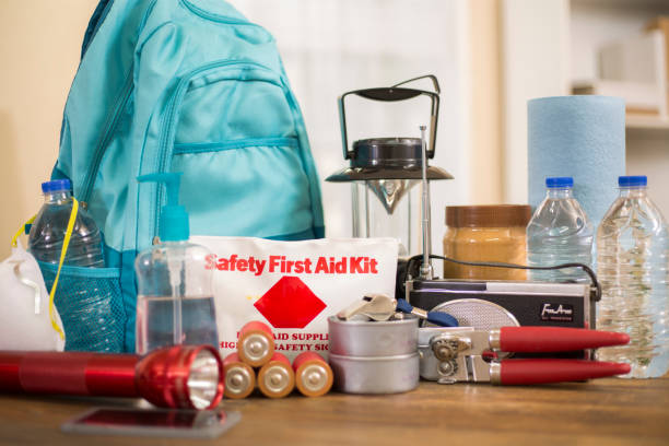 Emergency preparedness natural disaster supplies. Emergency preparedness supplies. A large collection of supplies to be used in case of a natural disaster (hurricane, flood, earthquake, etc) including flashlight, backpack, batteries, water bottles, first aid kit, lantern, radio, can opener and mask. No People. flood preparation stock pictures, royalty-free photos & images