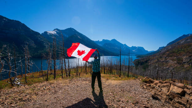 istock Waterton Lakes National Park and man with Canada flag 1278453097