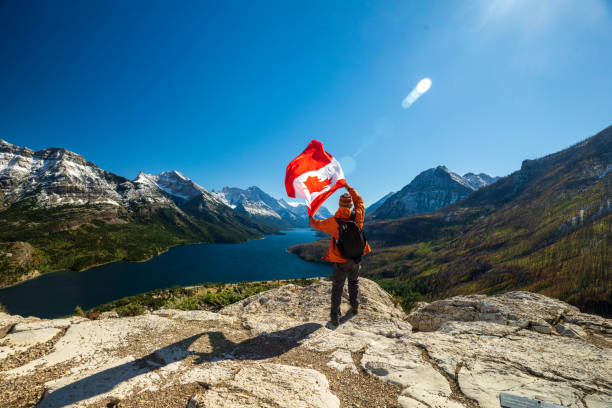 istock Waterton Lakes National Park and man with Canada flag 1278453110